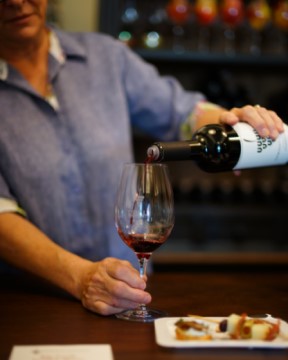 Woman pouring red wine